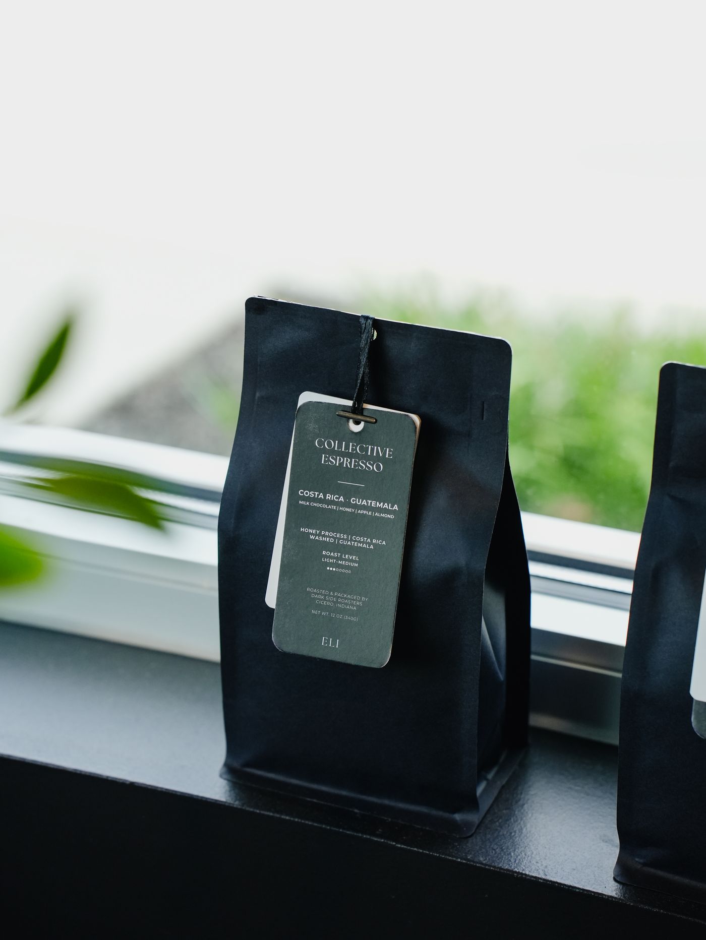 A bag of Collective Espresso standing on a windowsill