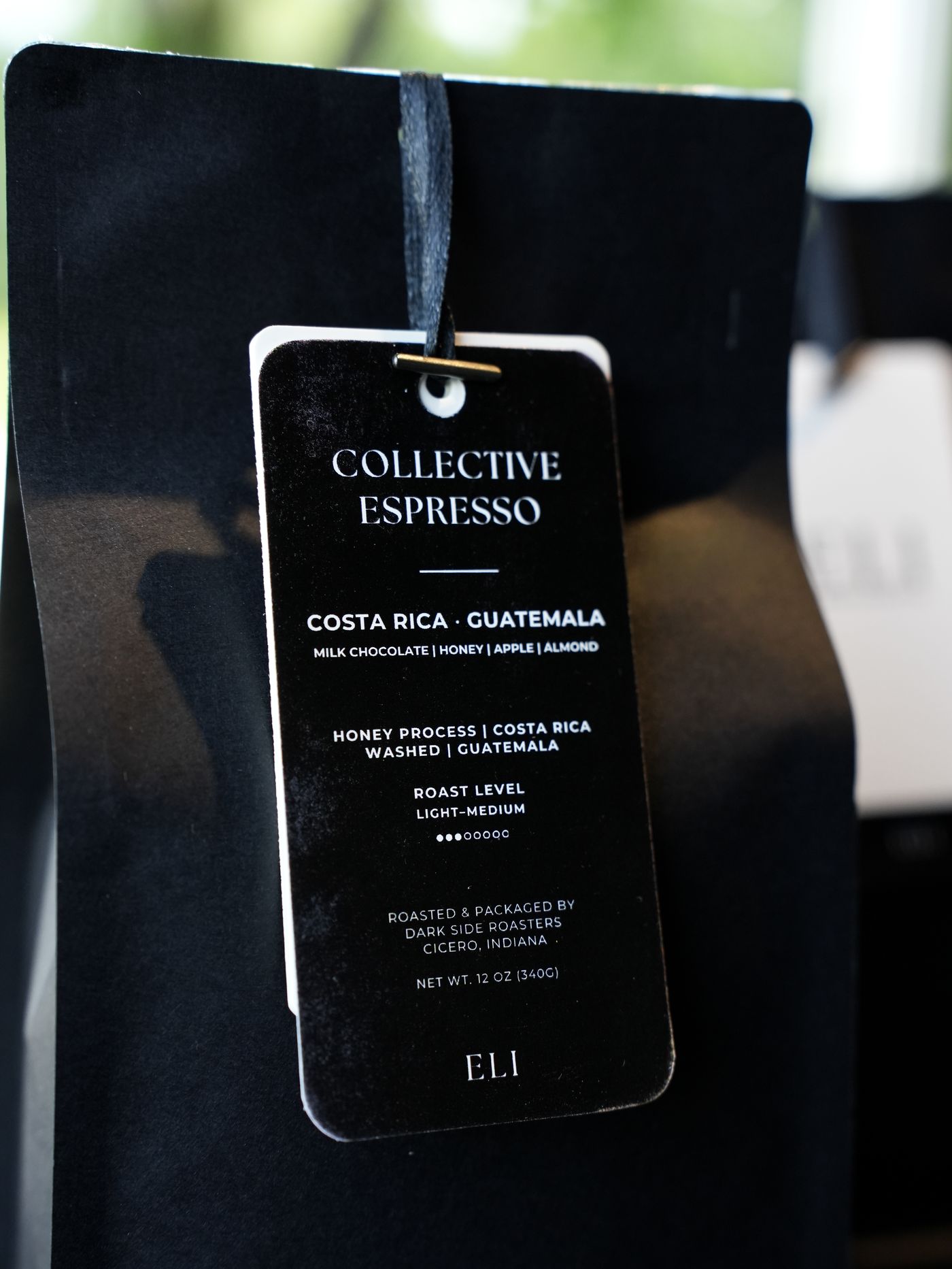 Close-up of the Collective Espresso tag: Costa Rica and Guatemala, light-medium roast, roasted by Dark Side Roasters in Cicero, Indiana