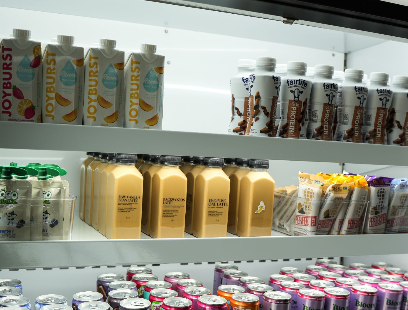 The grab-and-go fridge at Ozwell Fitness, bottled lattes on the shelf